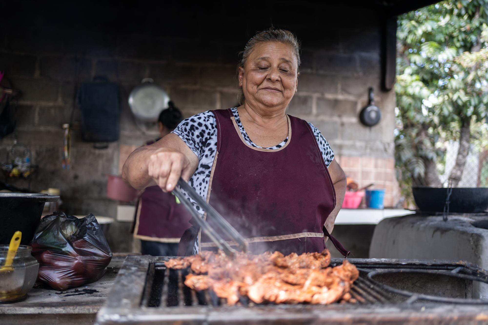 portrait poor latin poor woman cooking meat grill nicaragua 138670 4375